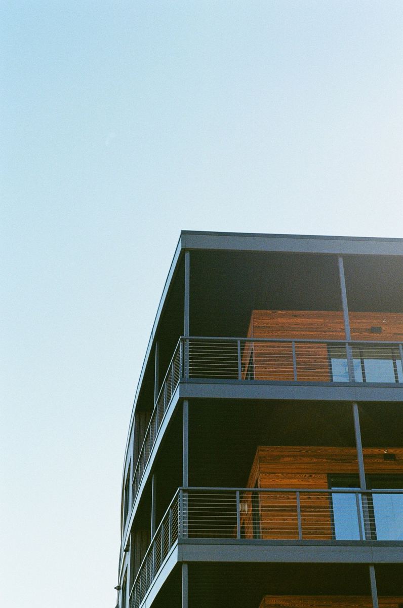 Modern condo building with wood-paneled balconies